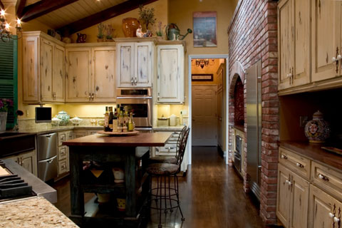 A kitchen island with traditional french appeal. It provides open storage 